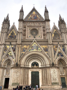 The stunning Cathedral of Siena, Italy, showcasing its intricate Gothic architecture and beautiful facade.